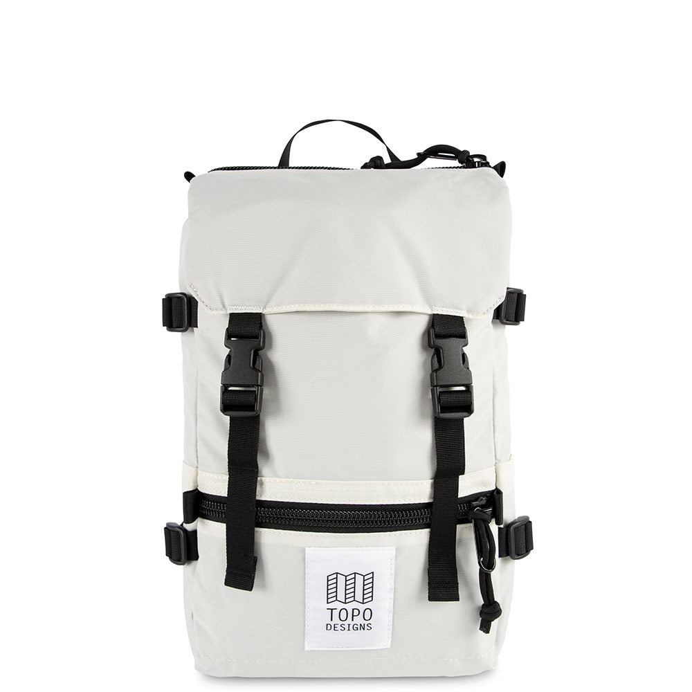 Topo Designs Mini Rover backpack in Natural white nylon with black nylon straps, black buckles, black zippers and white and black Topo Designs label on the front pocket. Item is shown on a white background.