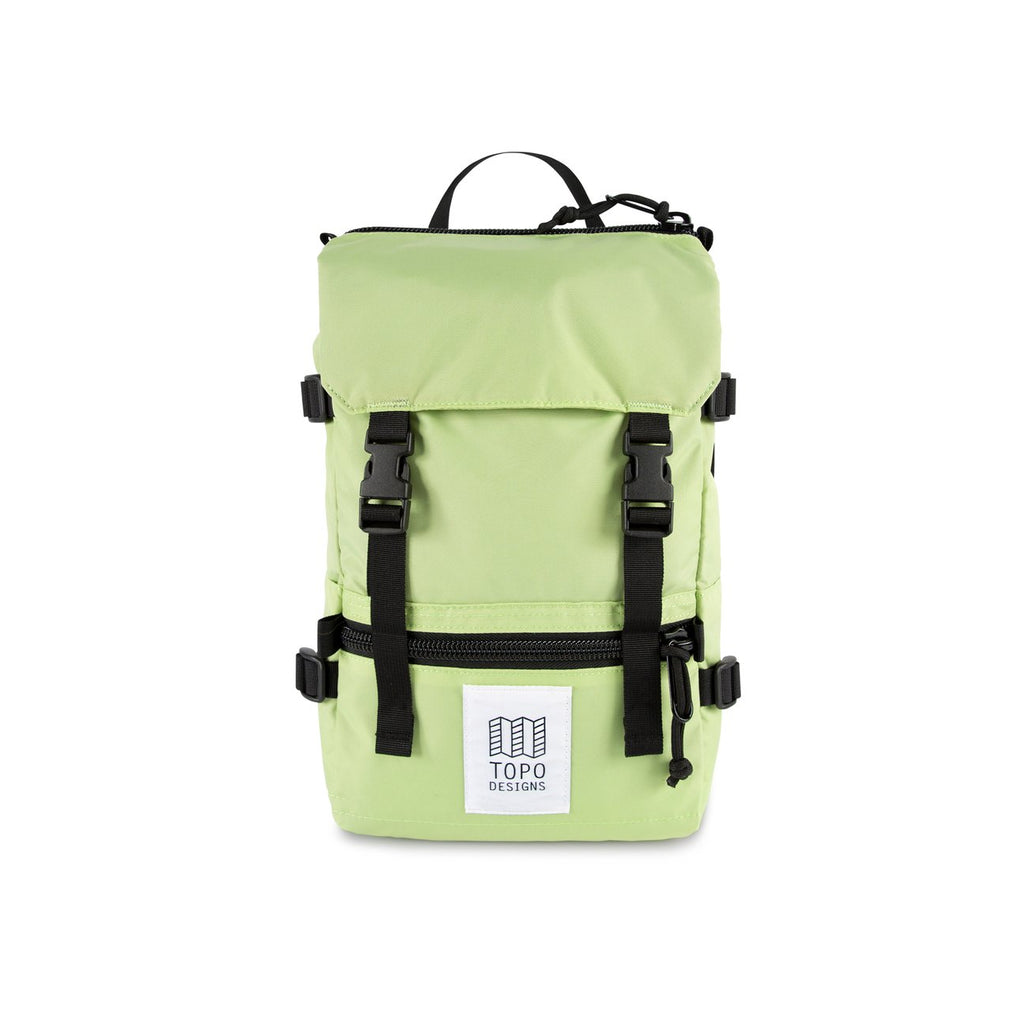 Topo Designs Mini Rover backpack in Light Green nylon with black nylon straps, black buckles, black zippers and white and black Topo Designs label on the front pocket. Item is shown on a white background.