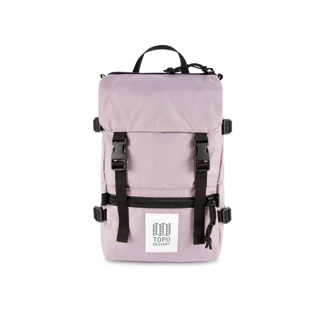 Topo Designs Mini Rover backpack in Light Purple nylon with black nylon straps, black buckles, black zippers and white and black Topo Designs label on the front pocket. 